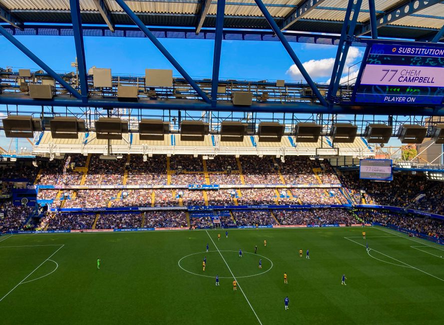 A lively football match in Stamford, England capturing the crowd and players in a filled stadium.